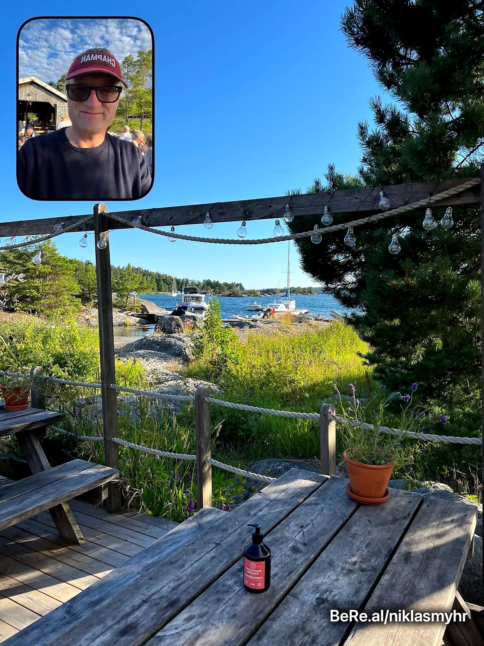 BeReal photo of a wooden table by the water on a Swedish island