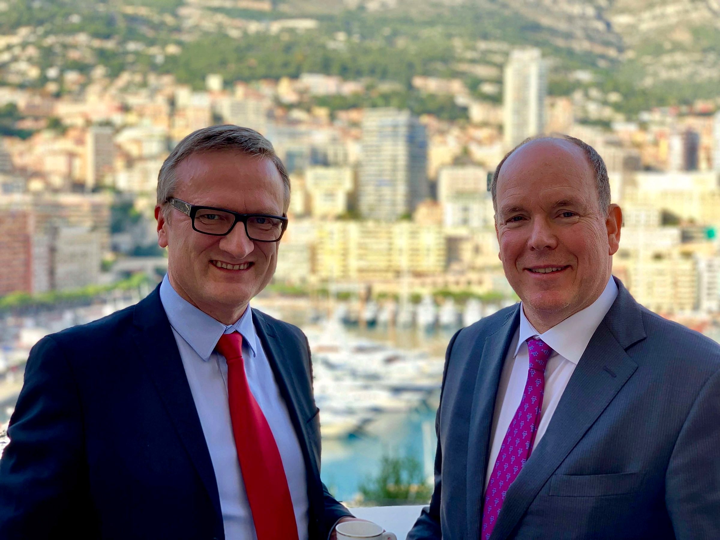Niklas Myhr with HSH Prince Albert II of Monaco, Monaco harbour behind them