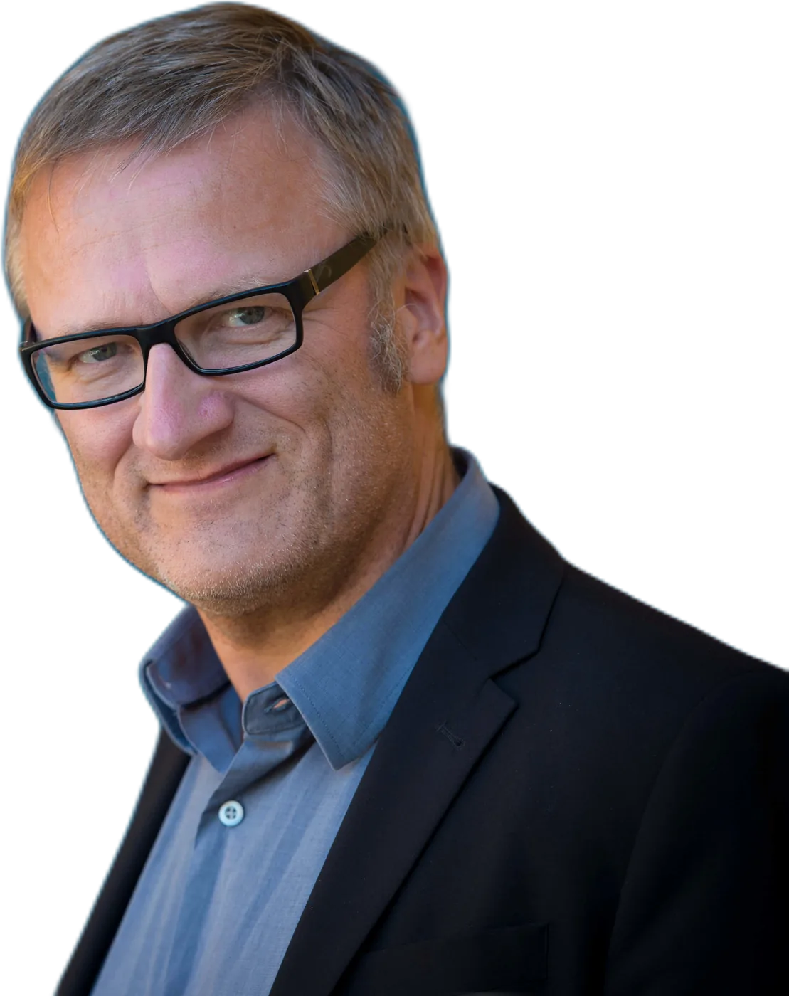 Niklas Myhr smiling, in glasses, a blue shirt and dark blazer