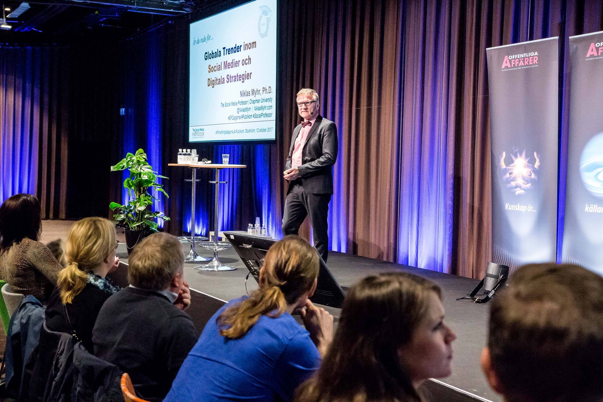 Niklas keynoting under purple stage light, Stockholm, 2017
